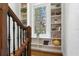 Staircase landing featuring built-in bookshelves and stained glass window at 136 W Davis Blvd, Tampa, FL 33606