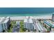 An aerial view of a beachfront condo building with a pool, beach access and covered parking at 1400 Gulf Blvd # 306, Clearwater Beach, FL 33767