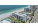 Aerial view of beachfront condo showing the community pool, landscaping, and beach access at 1400 Gulf Blvd # 306, Clearwater Beach, FL 33767