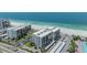Aerial view of beachfront condos highlighting location, parking and beach access at 1400 Gulf Blvd # 306, Clearwater Beach, FL 33767