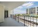 Balcony with views of the beach, nearby buildings, and a parking garage at 1400 Gulf Blvd # 306, Clearwater Beach, FL 33767