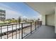 Enjoy the view of the street and beach beyond from this condo's private outdoor balcony with metal railing at 1400 Gulf Blvd # 306, Clearwater Beach, FL 33767