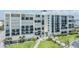Beautiful exterior of a beachfront condo with balconies, lush landscaping, and walking paths at 1400 Gulf Blvd # 306, Clearwater Beach, FL 33767