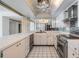 Bright kitchen featuring white cabinetry, black and white tile floors, and stainless steel appliances at 1400 Gulf Blvd # 306, Clearwater Beach, FL 33767