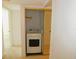 Hall closet hides a stacked laundry center with a white washer and dryer at 1400 Gulf Blvd # 306, Clearwater Beach, FL 33767
