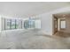 Spacious living room featuring large window and mirrors at 1400 Gulf Blvd # 306, Clearwater Beach, FL 33767