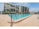 Enjoy the community pool at this condo building with plenty of chairs and lounge seating at 1400 Gulf Blvd # 306, Clearwater Beach, FL 33767