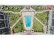 Aerial view of the outdoor pool area with lounge chairs surrounded by lush landscaping at 1400 Gulf Blvd # 306, Clearwater Beach, FL 33767