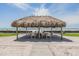 Enjoy a meal under the tiki hut with table and chairs near the beach at 1400 Gulf Blvd # 306, Clearwater Beach, FL 33767