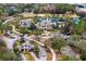 A beautiful aerial view of the community featuring manicured grounds, a pool, clubhouse and tennis courts at 14851 Tudor Chase Dr, Tampa, FL 33626