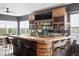 Finished basement bar featuring wood cabinets, a barrel accent, and a concrete countertop, perfect for entertaining guests at 14851 Tudor Chase Dr, Tampa, FL 33626