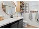 Modern bathroom with round mirror, wooden accents, and a decorative shower curtain at 14851 Tudor Chase Dr, Tampa, FL 33626