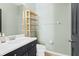 Well-lit bathroom with a wooden shelf and neutral color scheme at 14851 Tudor Chase Dr, Tampa, FL 33626