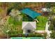 Aerial view of a community playground with a shaded play structure, swing set, and basketball court at 14851 Tudor Chase Dr, Tampa, FL 33626
