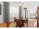 Cozy dining room with wood floors, neutral rug, plantation shutters, and modern light fixture at 14851 Tudor Chase Dr, Tampa, FL 33626