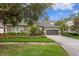 Beautiful home with lush landscaping, brick driveway, and a well-maintained front yard at 14851 Tudor Chase Dr, Tampa, FL 33626