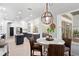 Stylish kitchen with an eat in area, stainless appliances, island, and modern light fixtures at 14851 Tudor Chase Dr, Tampa, FL 33626