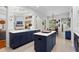 Open-concept kitchen featuring an island with quartz countertops and stainless steel appliances at 14851 Tudor Chase Dr, Tampa, FL 33626