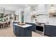Modern kitchen with stainless steel appliances, white subway tile, and contrasting blue cabinets at 14851 Tudor Chase Dr, Tampa, FL 33626
