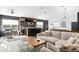 Open-concept living room with comfortable seating, a bar, and a game table at 14851 Tudor Chase Dr, Tampa, FL 33626
