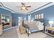 Spacious main bedroom with decorative tray ceiling, plenty of natural light, and walk-in closet at 14851 Tudor Chase Dr, Tampa, FL 33626