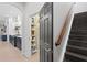 Pantry adjacent to kitchen and entry to stairs, with stocked shelves at 14851 Tudor Chase Dr, Tampa, FL 33626