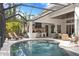 Screened pool and outdoor kitchen area perfect for entertaining and relaxation with lounge chairs and a grill at 14851 Tudor Chase Dr, Tampa, FL 33626