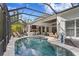 Large screened-in pool area with outdoor kitchen and seating areas perfect for enjoying outdoor living and entertaining at 14851 Tudor Chase Dr, Tampa, FL 33626