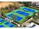 Aerial view of tennis courts surrounded by lush palm trees at 14851 Tudor Chase Dr, Tampa, FL 33626