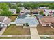 Aerial view of home featuring fenced-in pool, lush greenery, and yellow exterior at 1624 Shady Leaf Dr, Valrico, FL 33596