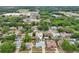 Aerial view of neighborhood showcasing home with pool, lush greenery, and surrounding amenities at 1624 Shady Leaf Dr, Valrico, FL 33596