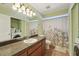 Bathroom featuring a single sink vanity with wood cabinets, and a floral shower curtain at 1624 Shady Leaf Dr, Valrico, FL 33596