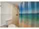 Shower with a showerhead featuring blue shower curtain, tiled wall and floor, and window at 1624 Shady Leaf Dr, Valrico, FL 33596