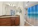 Bathroom featuring a single sink vanity with wood cabinets, and a shower with blue shower curtain at 1624 Shady Leaf Dr, Valrico, FL 33596