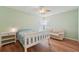 Bedroom featuring wood-look floors, a ceiling fan, a bed, and a sofa at 1624 Shady Leaf Dr, Valrico, FL 33596