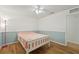 Comfortable bedroom features hardwood floors, a ceiling fan, and a window with bright natural light at 1624 Shady Leaf Dr, Valrico, FL 33596