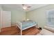 Bedroom featuring wood-look floors, a ceiling fan, a bed, and a sofa at 1624 Shady Leaf Dr, Valrico, FL 33596