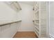 Closet featuring custom shelving units and tiled floor at 1624 Shady Leaf Dr, Valrico, FL 33596