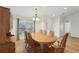 Bright dining area with hardwood floors, large window and stylish chandelier at 1624 Shady Leaf Dr, Valrico, FL 33596