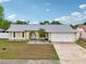 Charming single Gathering home with well manicured lawn and two-car garage at 1624 Shady Leaf Dr, Valrico, FL 33596