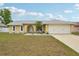 Charming single-story home featuring a well-manicured lawn and attached two-car garage at 1624 Shady Leaf Dr, Valrico, FL 33596