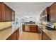 Kitchen with stainless steel appliances and dark wood cabinetry that opens to the living room at 1624 Shady Leaf Dr, Valrico, FL 33596