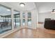 Bright living room showcasing a wall of windows with views of a covered pool at 1624 Shady Leaf Dr, Valrico, FL 33596