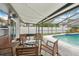 Relaxing covered patio with comfortable seating area and view of the refreshing screened-in pool at 1624 Shady Leaf Dr, Valrico, FL 33596