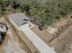 Aerial view of a home featuring fenced yard and a long driveway with a convenient two car garage at 16519 Us Highway 41, Spring Hill, FL 34610