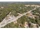 Aerial shot shows the local landscape with trees, roads, business and residences at 16519 Us Highway 41, Spring Hill, FL 34610