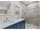 Bathroom featuring a double sink vanity with a stone countertop, shower, and modern fixtures at 16519 Us Highway 41, Spring Hill, FL 34610