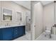 Stylish bathroom with double vanity, custom blue cabinets, and a glass-enclosed shower at 16519 Us Highway 41, Spring Hill, FL 34610
