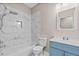 Bathroom with marbling shower tile and stylish blue vanity at 16519 Us Highway 41, Spring Hill, FL 34610