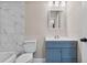 Bathroom features modern blue vanity and marbling tile shower at 16519 Us Highway 41, Spring Hill, FL 34610